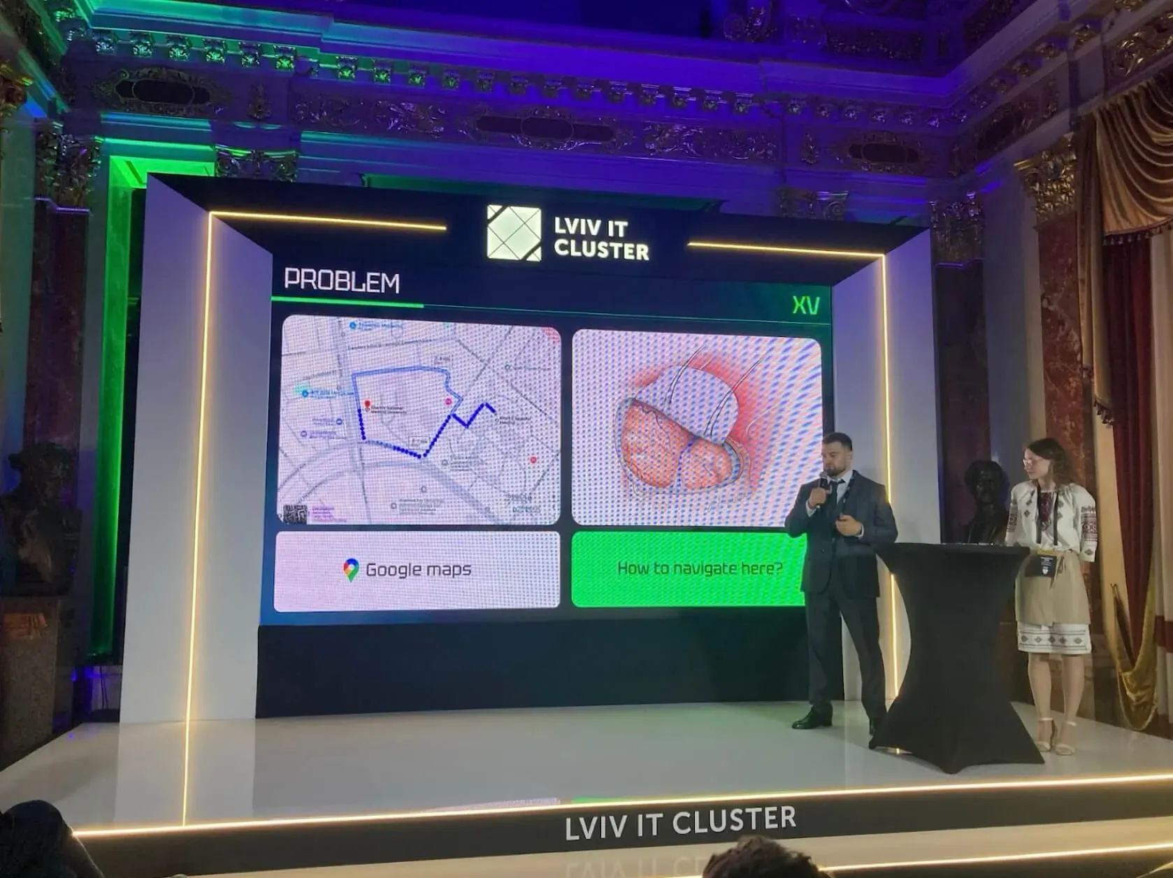 The eXtra Vision team presenting on the Lviv IT Cluster stage, the screen showing a map beside a surgical illustration and the question How to navigate here?