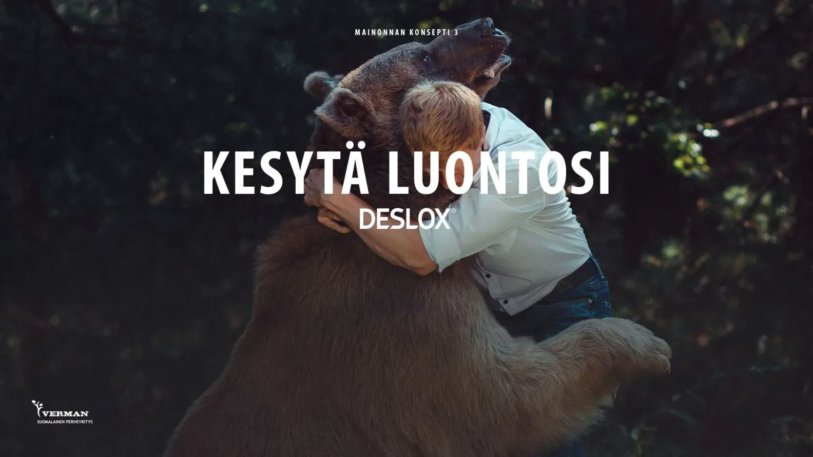 A child hugging a large bear in a dark forest, with the line Kesytä luontosi and the Deslox logo.