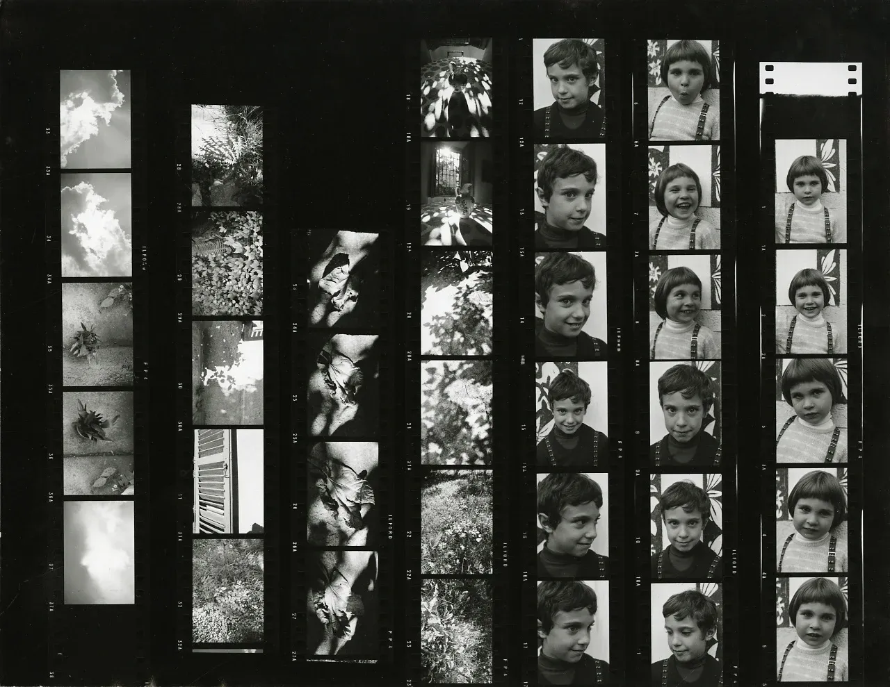 Black-and-white contact sheet: strips of clouds, leaves and shadows, and portraits of two children, frame after frame.