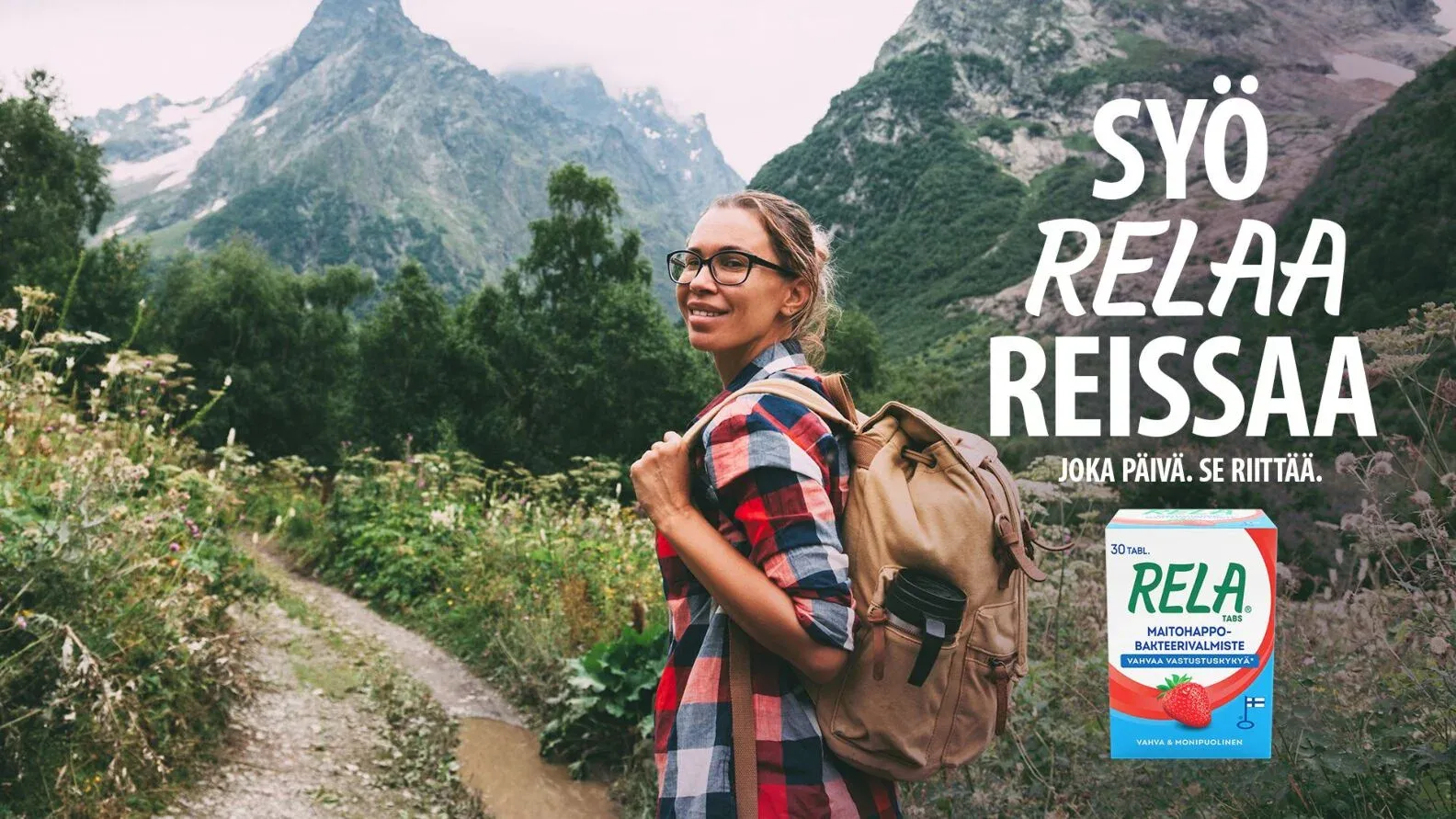 A woman with a backpack on a mountain trail, beside the line Syö. RELAA. Reissaa. and a RELA pack.